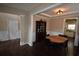 Spacious dining room with a tray ceiling and dark hardwood floors, adjacent to a kitchen at 106 Puckett Ct, Canton, GA 30115