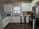 Well-lit kitchen featuring white cabinets, granite countertops, and stainless steel appliances at 106 Puckett Ct, Canton, GA 30115