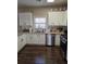 Bright kitchen with white cabinets, stainless steel appliances, and granite countertops at 106 Puckett Ct, Canton, GA 30115