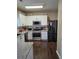 Modern kitchen with stainless steel appliances, granite countertops, and dark hardwood floors at 106 Puckett Ct, Canton, GA 30115