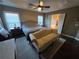 Spacious main bedroom featuring a tray ceiling, ceiling fan, and ensuite bathroom at 106 Puckett Ct, Canton, GA 30115