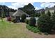 Community pool area surrounded by manicured greenery and trees at 106 Puckett Ct, Canton, GA 30115