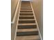 Carpeted staircase with painted handrail, connecting the home's various levels at 106 Puckett Ct, Canton, GA 30115