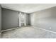 Cozy bedroom features neutral gray walls, soft carpeting, and a window with decorative curtains at 1057 Falling Water Se Dr, Smyrna, GA 30080