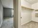 Bedroom boasts soft grey walls and plush carpeting, leading to a tidy closet with built-in shelves at 1057 Falling Water Se Dr, Smyrna, GA 30080