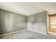 Neutral bedroom with carpet and grey paint adjoins an open doorway to a brightly lit hallway at 1057 Falling Water Se Dr, Smyrna, GA 30080