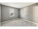 Empty bedroom features gray walls, carpet, and a large window at 1057 Falling Water Se Dr, Smyrna, GA 30080