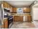 Bright kitchen features stainless steel appliances, light wood cabinets, and hardwood floors at 1057 Falling Water Se Dr, Smyrna, GA 30080