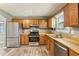 Bright kitchen features stainless steel appliances, light wood cabinets, and hardwood floors at 1057 Falling Water Se Dr, Smyrna, GA 30080