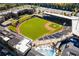 Aerial view of a baseball field with modern apartments and a swimming pool, showcasing the community's amenities at 6969 Melody Dr, Buford, GA 30518
