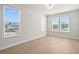 Bright, empty bedroom featuring natural light, neutral paint, and stylish hardwood flooring, ready to be personalized at 6969 Melody Dr, Buford, GA 30518