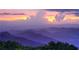 Scenic mountain range view with a beautiful sunset featuring colorful clouds and rolling hills at 6969 Melody Dr, Buford, GA 30518