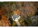An aerial shot of the home in a wooded neighborhood, showcasing a well-maintained landscape and large trees at 1472 Lachona Ct, Atlanta, GA 30329