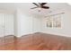Bright bedroom featuring hardwood floors, a ceiling fan, two closets and a window at 1472 Lachona Ct, Atlanta, GA 30329
