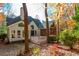 Rear exterior featuring a deck, screened-in porch, stone walkway, and lush landscaping at 1472 Lachona Ct, Atlanta, GA 30329
