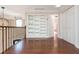 Second floor hallway featuring hardwood floors, custom built-in shelving, and modern lighting at 1472 Lachona Ct, Atlanta, GA 30329