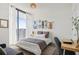 Bright bedroom with large window, light fixture, desk, and comfortable seating area; modern decor at 788 W Marietta Nw St # 403, Atlanta, GA 30318