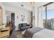 Modern bedroom featuring hardwood floors, large windows, desk and sitting area with artwork at 788 W Marietta Nw St # 403, Atlanta, GA 30318