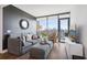 Stylish living room with city views from large windows, gray walls and floors at 788 W Marietta Nw St # 403, Atlanta, GA 30318