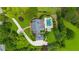 Aerial view of the luxurious home featuring manicured lawns, a pool with a spa, and private driveway at 710 Cox Rd, Roswell, GA 30075