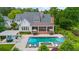 Aerial view of a home's backyard showcasing a pool, pergola, patio, and beautifully landscaped grounds at 710 Cox Rd, Roswell, GA 30075