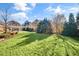 Lush backyard featuring a pergola and a sprawling lawn, creating a picturesque setting for outdoor activities and relaxation at 710 Cox Rd, Roswell, GA 30075