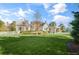 Expansive backyard featuring lush green lawns, a charming pergola, and a well-maintained garden, ideal for Gathering enjoyment at 710 Cox Rd, Roswell, GA 30075