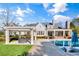 Beautiful backyard with a pool, pergola, and landscaped yard, creating an ideal space for outdoor living and entertaining at 710 Cox Rd, Roswell, GA 30075