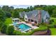 Backyard pool area with an outdoor lounge, dining area, and meticulously manicured hedges at 710 Cox Rd, Roswell, GA 30075