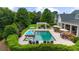 Backyard pool area with an outdoor lounge, dining area, and meticulously manicured hedges at 710 Cox Rd, Roswell, GA 30075