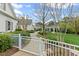 Landscaped backyard with a charming pergola, stone pathway, and a white picket fence surrounding the property at 710 Cox Rd, Roswell, GA 30075