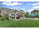 Expansive backyard featuring a white pergola, outdoor seating, a pool, and lush green lawn at 710 Cox Rd, Roswell, GA 30075
