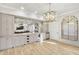 Stunning bar area with mirrored backsplash, granite counters, wine fridge, and decorative light fixture at 710 Cox Rd, Roswell, GA 30075