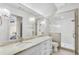 Modern bathroom features a double vanity with stone countertops, sleek lighting, and a glass-enclosed shower at 710 Cox Rd, Roswell, GA 30075