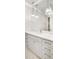 Stylish bathroom featuring a marble countertop, cabinetry, and pendant lighting at 710 Cox Rd, Roswell, GA 30075