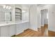 Bright bathroom with hardwood floors offers double sinks, storage, and easy access to closet at 710 Cox Rd, Roswell, GA 30075