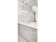 Bathroom featuring double sinks, marble countertops, and pendant lights above a large mirror at 710 Cox Rd, Roswell, GA 30075
