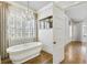 Spa-like bathroom features a freestanding tub, bright windows, and a modern chandelier at 710 Cox Rd, Roswell, GA 30075