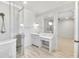 Bathroom with marble-topped vanity, tile shower, glass surround, and tile floors at 710 Cox Rd, Roswell, GA 30075