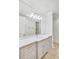 Elegant bathroom vanity with marble countertop, decorative mirror, and soft gray cabinetry at 710 Cox Rd, Roswell, GA 30075