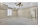 Bright bedroom features neutral walls, white trim, plush carpet, and an ensuite bathroom at 710 Cox Rd, Roswell, GA 30075