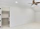 Bedroom with a walk-in closet, neutral carpet, ceiling fan, and white walls at 710 Cox Rd, Roswell, GA 30075