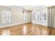 Spacious bedroom with hardwood floors, natural light, and elegant window treatments at 710 Cox Rd, Roswell, GA 30075