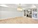Large bonus room with light hardwood floors and glass-paneled doors that provide a clear view to a home gym at 710 Cox Rd, Roswell, GA 30075