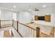 Upstairs bonus room featuring a beamed ceiling, barn door, and hardwood floors at 710 Cox Rd, Roswell, GA 30075