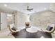 Bonus room features whitewashed wall paneling, plush seating, ceiling fan, and access to a bathroom at 710 Cox Rd, Roswell, GA 30075
