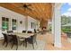 Inviting covered patio with brick fireplace, outdoor dining area, and comfortable seating at 710 Cox Rd, Roswell, GA 30075