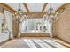 Spacious brick-walled dining area with hardwood floors, chandeliers, and access to the outdoors at 710 Cox Rd, Roswell, GA 30075