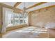 Elegant dining area with exposed brick walls, chandeliers, large windows, and hardwood floors at 710 Cox Rd, Roswell, GA 30075