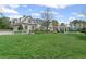 Expansive green lawn showcasing a home with a pool, outdoor seating, and a white picket fence at 710 Cox Rd, Roswell, GA 30075